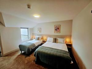 Voodi või voodid majutusasutuse Tatlers Guest House toas