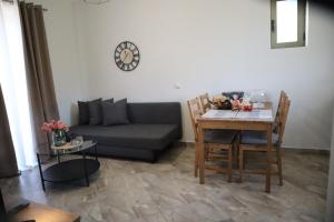 a living room with a couch and a table at Elaionas Apartments 2 in Riglia