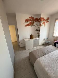 a bedroom with a bed and a plant on the wall at Amicizia in Valledoria +16 photos