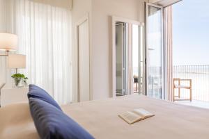 Postel nebo postele na pokoji v ubytování Hotel Capanni + 27 fotografií