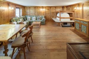 a living room filled with furniture and a wooden floor at Villa Lacedel - Stayincortina in Cortina dʼAmpezzo