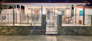a house with a gate in front of it at Bright-living in Asprovalta