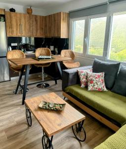a living room with a couch and a table at G.Tzanis Luxury Apartments in Parga