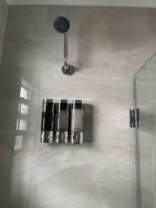 a shower with a mirror and a shower head at Private Room in the Heart of Calle Ocho in Miami