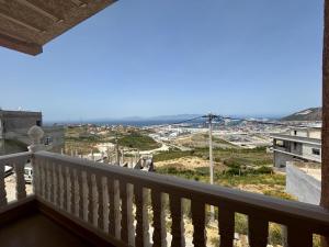 a balcony with a view of a city at Appartement à Houma, proche Port Tanger Med in Dalia
