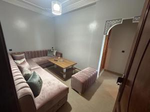 a living room with a couch and a table at Appartement à Houma, proche Port Tanger Med in Dalia
