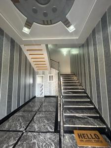 a hallway with a staircase in a building at Appartement à Houma, proche Port Tanger Med in Dalia