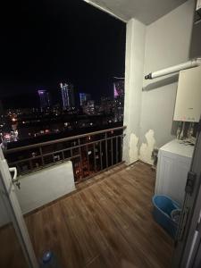 a balcony with a view of a city at night at Levanis in Batumi