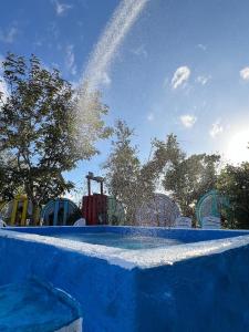 a water park with a water shooting up into the sky at 與大自然融合的包棟小屋 in Hengchun