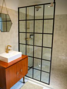 a bathroom with a sink and a glass shower at BnB 117 in Amsterdam +9 photos