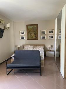 1 dormitorio con 1 cama y cuadros en la pared en Fontane Bianche Guest Rooms, en Fontane Bianche