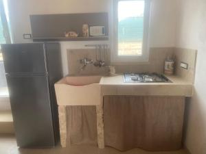 a small kitchen with a sink and a refrigerator at Matine & Matine - Salento Selection in Tricase