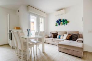 a living room with a table and a couch at Brand new 3 bedrooms apartment in Navigli area in Milan +19 photos