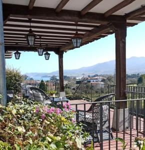 a wooden pergola with tables and chairs on a patio at Hotel Los Caspios in Colunga