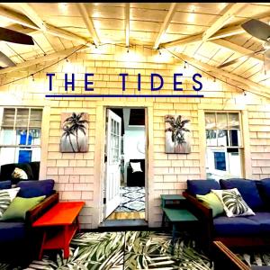 a building with a sign that reads the tides at The Tides in Hampton