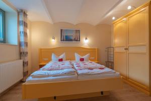 a bedroom with a large bed with red pillows at Villa Stock Wohnung VS 5 im Souterrain in Heringsdorf