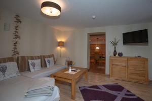 a living room with a couch and a table at Villa Stock Wohnung VS 5 im Souterrain in Heringsdorf