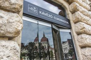 a reflection of a building in the window of a store at Anabelle Bed and Budapest in Budapest