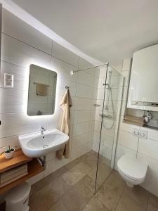a bathroom with a sink and a toilet and a shower at Nagerhof in Gnesau +50 photos