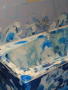 a blue and white bath tub in a bathroom at ApartMarin in Trogir