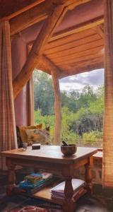 a table in front of a window in a room at Tara vegetarian retreat guesthouse in Carmarthen