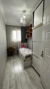 a small bedroom with a bed and a door at Tatas Place in Batumi