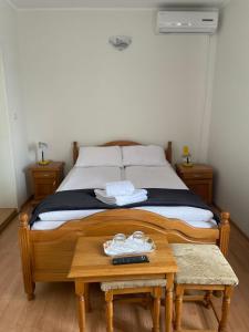 a bedroom with a bed with two shoes on a table at Pensiunea Olimp in Arad