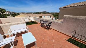 a patio with chairs and tables on a balcony at Appartamento Le Vele in Porto San Paolo