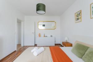 a white bedroom with a bed and a sink at Ferienwohnung Anton in Dessau