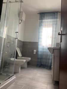 a bathroom with a toilet and a sink and a shower at Nonna Lella in Ripa Teatina