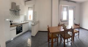 a kitchen with a wooden table and chairs in a kitchen at Nonna Lella in Ripa Teatina +2 photos
