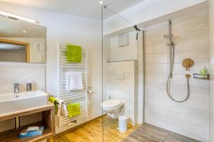a bathroom with a shower and a toilet and a sink at Das Kleemanns - Nur für Erwachsene in Mittelberg
