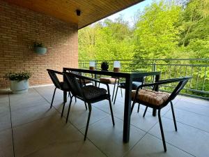 a black table and chairs on a patio at Stilvolles Apartment mit Waldblick in Bad Bentheim