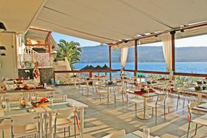 a restaurant with a view of the ocean at Samos Bay Hotel by Gagou Beach in Samos