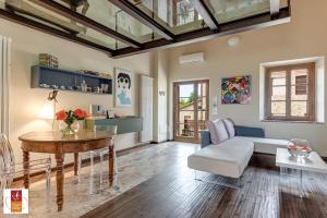 a living room with a table and a couch at Chianti B&B Design infinity pool shared in Pianella