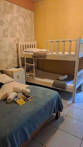 a room with two bunk beds in a room at Pousada Cabocla - 300 metros da Ilha do Amor in Alter do Chao