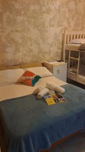 a stuffed animal laying on top of a bed at Pousada Cabocla in Alter do Chao