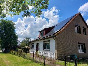 a house with a solar roof on top of it at In Summo Monte in Ottersberg