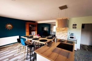 a kitchen with a table and chairs in a room at La COSY CASA in Grande-Synthe
