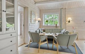 a living room with a table and chairs at Gorgeous Home In Asnæs With Kitchen in Asnæs