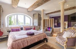 a bedroom with a large bed and a large window at Nice Home In Orgon With Private Swimming Pool, Can Be Inside Or Outside in Orgon