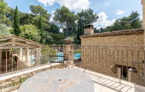 an outside view of a brick building with a fountain at Amazing Home In Orgon in Orgon