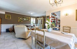 a living room with a large table and chairs at Awesome Home In Bédarrides in Bédarrides