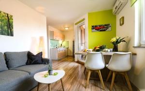 a living room with a couch and a kitchen at AS apartmani "Pistachio" in Peroj