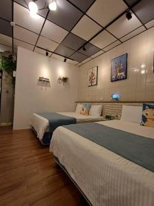 1 dormitorio con 2 camas y sofá en 鹿鹿咪民宿 en Lugang