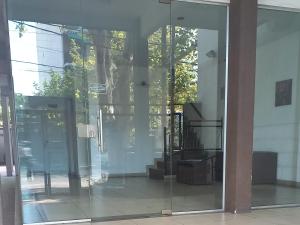 an entrance to a building with a revolving door at Faluma Quilmes in Quilmes