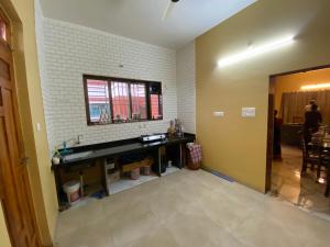 a living room with a desk and a window at Utsav villas in Dapoli