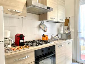 Il comprend une cuisine équipée d'une cuisinière et d'un évier. dans l'établissement Cristina Boutique Apartment with Terrace, à Viareggio