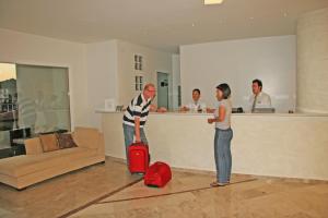
a man standing next to a woman in a room at Samos Bay Hotel by Gagou Beach in Samos
