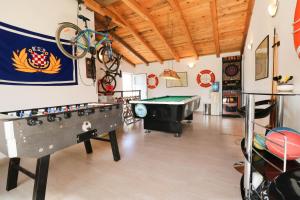 a room with a pool table and a bike on the wall at AS apartmani "Pistachio" in Peroj